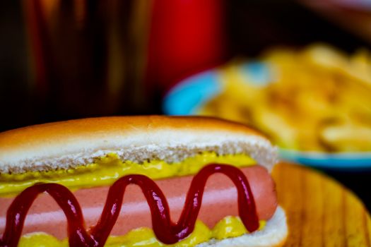 Hot dog and chips on wooden background