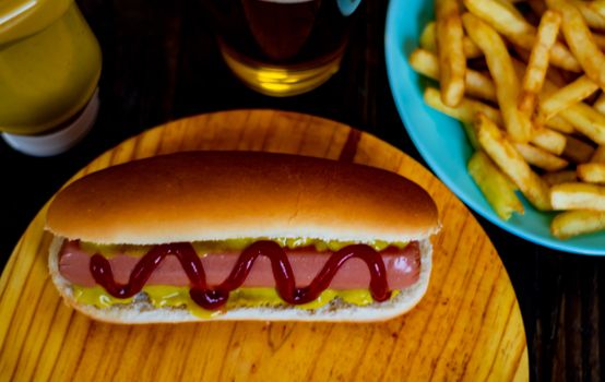 Hot dog and chips on wooden background