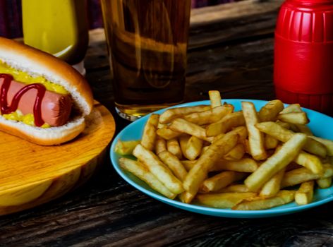 Hot dog and chips on wooden background