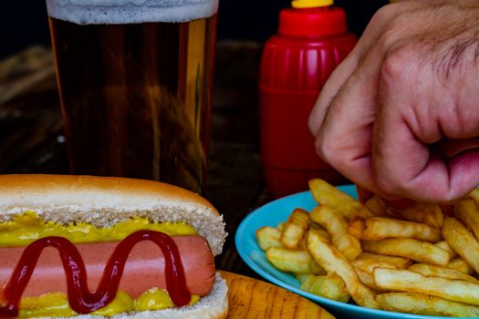 Hot dog and chips on wooden background