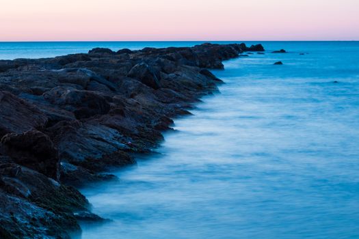 Breakwater at Burriana beach in long exposure