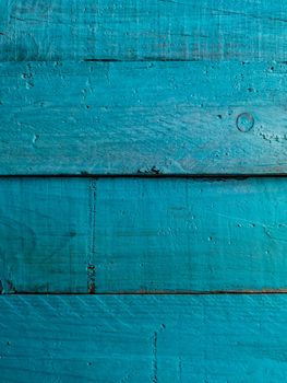 Old and worn wooden background painted blue