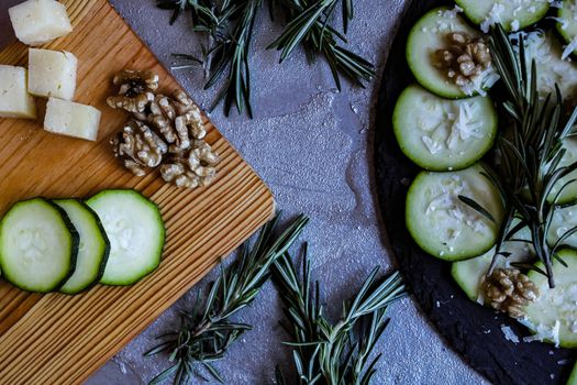 Carpaccio of zucchini with nuts and cheese on gray background