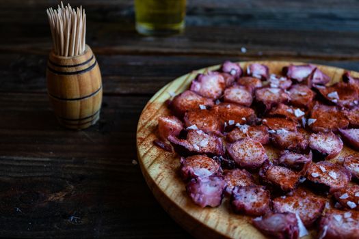 View of Galician octopus dish on old wooden background