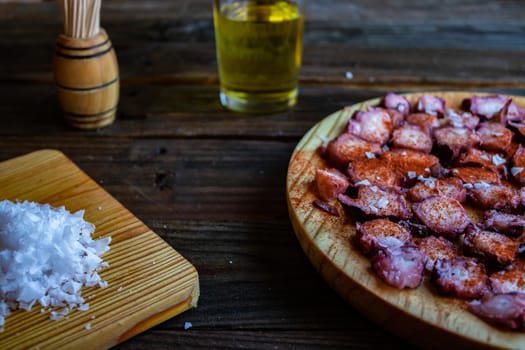 View of Galician octopus dish on old wooden background