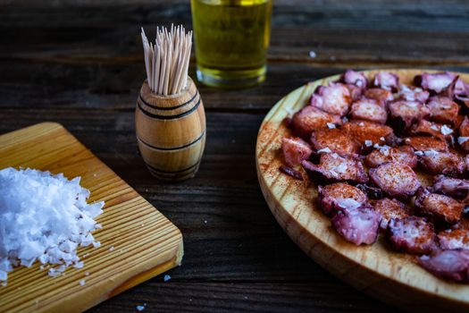 View of Galician octopus dish on old wooden background