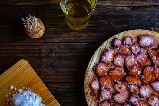 View of Galician octopus dish on old wooden background