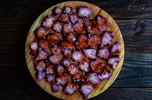 View of Galician octopus dish on old wooden background