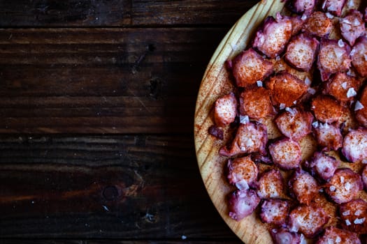 View of Galician octopus dish on old wooden background