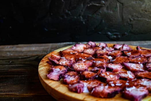 View of Galician octopus dish on old wooden background
