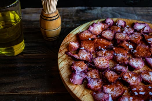View of Galician octopus dish on old wooden background