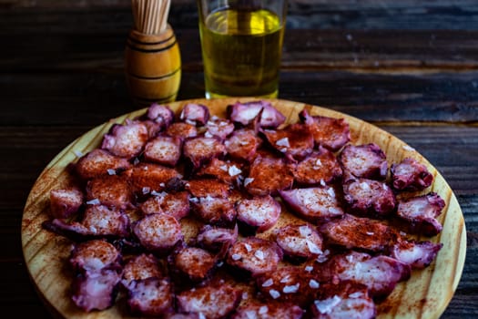 View of Galician octopus dish on old wooden background