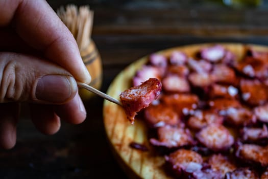 View of Galician octopus dish on old wooden background