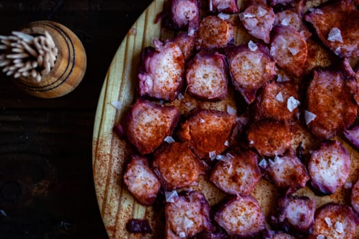 View of Galician octopus dish on old wooden background