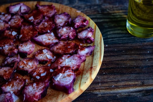 View of Galician octopus dish on old wooden background