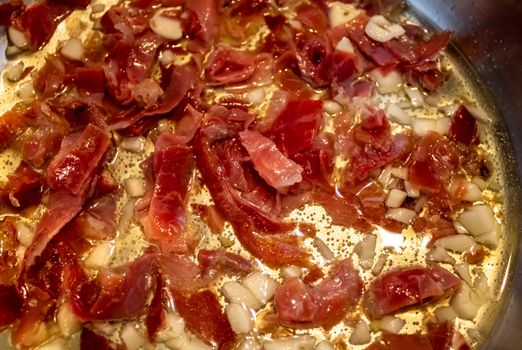 Stir fried garlic and ham in olive oil
