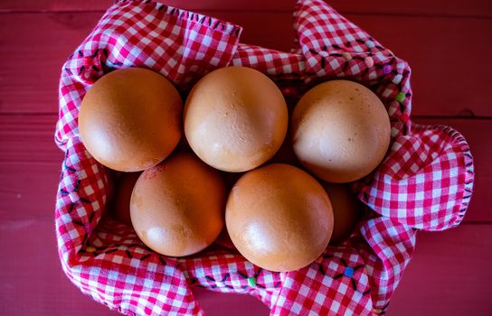 View of egg basket with checkered tablecloth