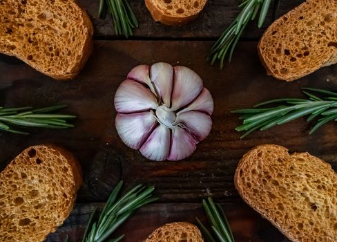 Ingredients for garlic soup in composition on wooden background