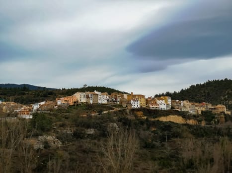 View of the mountain village of Fuente de la Reina with gray sky