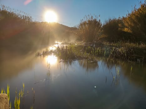 River with water evaporating on a very cold morning in the mountain