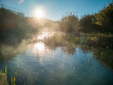 River with water evaporating on a very cold morning in the mountain