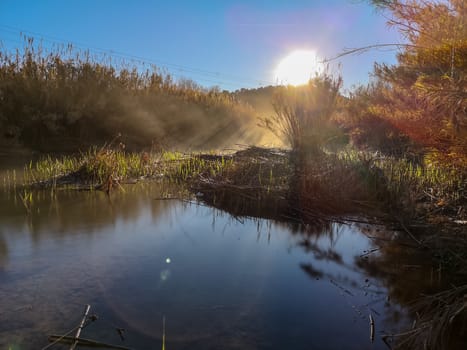 River with water evaporating on a very cold morning in the mountain