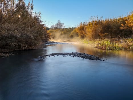 River with water evaporating on a very cold morning in the mountain