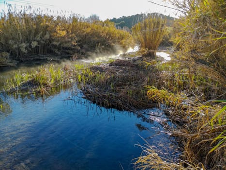 River with water evaporating on a very cold morning in the mountain
