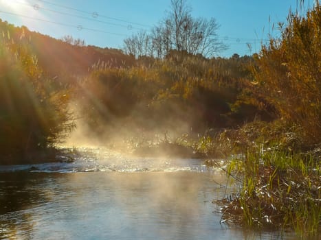 River with water evaporating on a very cold morning in the mountain