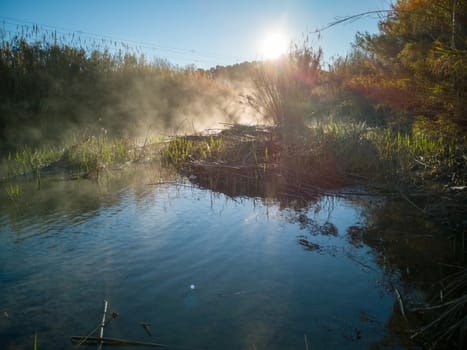 River with water evaporating on a very cold morning in the mountain