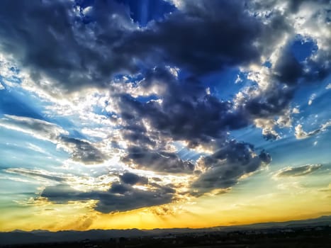 Sunset with threatening storm clouds over mountains