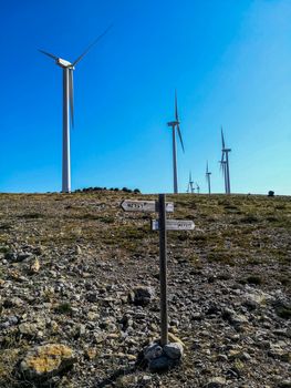 Wind generators on the mountain with blue sky in the background