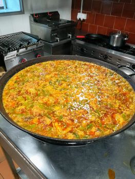 Typical Spanish food of rice, meat and vegetables in special flat casserole for this meal