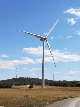 Wind generators on the mountain with blue sky in the background