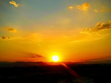 Sunset over the mountains in orange, yellow and red tones