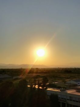 Sunset over the mountains in orange, yellow and red tones