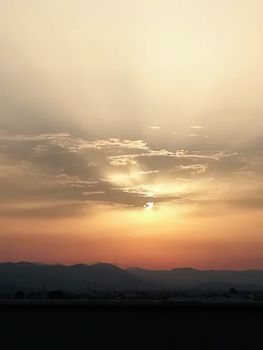 Sunset with threatening storm clouds over mountains