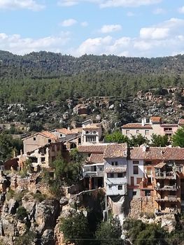 Ancient hanging houses of the mountain village of Fuente de la Reina with mountains in the background