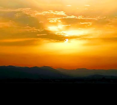 Sunset with threatening storm clouds over mountains
