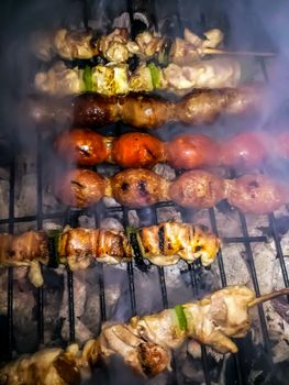 Barbecue with sausage and smoked skewers