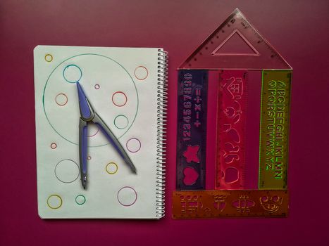 Various school material in composition on purple background