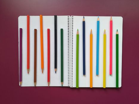Various school material in composition on purple background