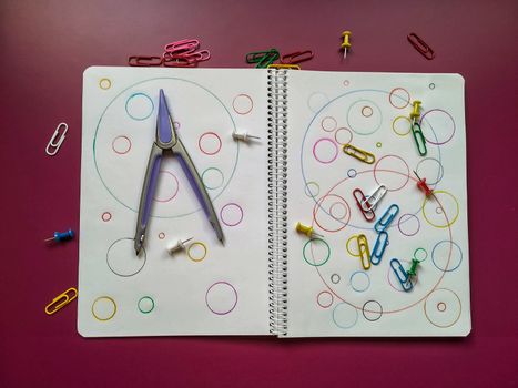 Various school material in composition on purple background