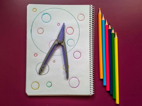 Various school material in composition on purple background
