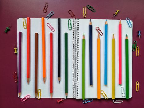 Various school material in composition on purple background