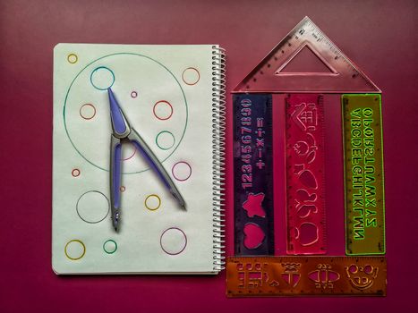 Various school material in composition on purple background