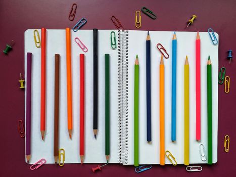 Various school material in composition on purple background