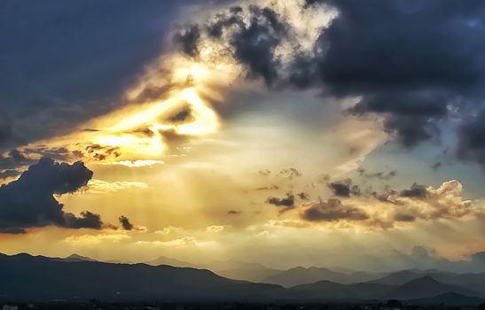 Sunset with threatening storm clouds over mountains