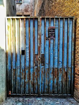 Blue door with rusty metal in a Segorbe alley