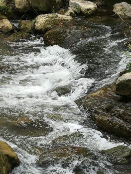 Rocks forming a small dam in the Palancia river as it passes through Segorbe